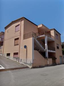 a building with a staircase on the side of a street at "SHARDANA" CASA VACANZe in Gonnesa