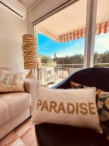 a living room with a couch and a large window at Eden B7 Appartement in Saint-Tropez