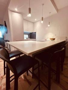 a kitchen with a large white table and chairs at Eden B7 Appartement in Saint-Tropez