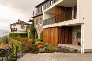 an external view of a house with a balcony at FLH Douro Casa do Mártir in Vila Marim