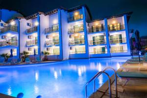 a swimming pool in front of a hotel at night at Royal Calisto Hotel in Sozopol