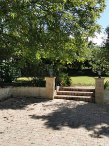 a set of stairs in a park with a tree at Grenier de l'IRIS in Sainte-Croix-sur-Mer +3 photos