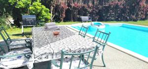 a table and chairs next to a swimming pool at Villagalicia360 in Bergondo