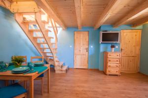 ein Wohnzimmer mit einer Holztreppe und einem Tisch in der Unterkunft Alpejska Wioska in Istebna