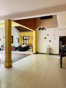 a large living room with a couch and a table at Osara Holiday Home in Anuradhapura