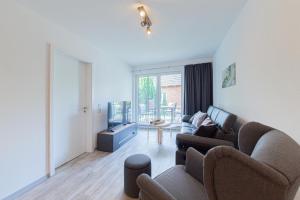 a living room with a couch and a table at Ferienwohnung Stern 3 Scharbeutz in Scharbeutz