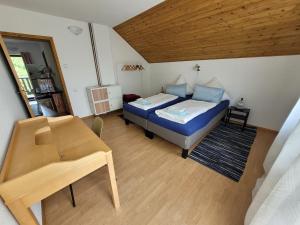 a small bedroom with a bed and a table at Holiday house SuPer in Slunj