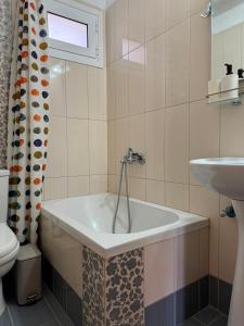 a bathroom with a tub and a sink at Anemi Stay in Kithnos