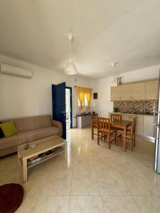 a living room with a couch and a table at Anemi Stay in Kithnos