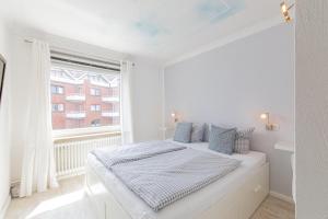 Postel nebo postele na pokoji v ubytování Ferienwohnung Strandkörbchen - Scharbeutz