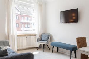 TV a/nebo společenská místnost v ubytování Ferienwohnung Strandkörbchen - Scharbeutz
