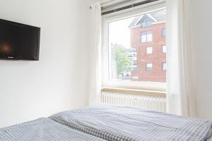 TV a/nebo společenská místnost v ubytování Ferienwohnung Strandkörbchen - Scharbeutz