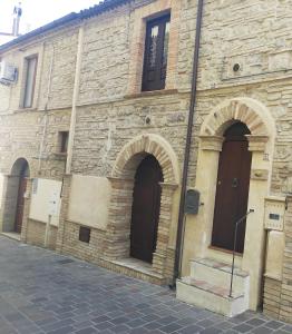 an old stone building with arches on a street at Casa Nicolì in San Salvo