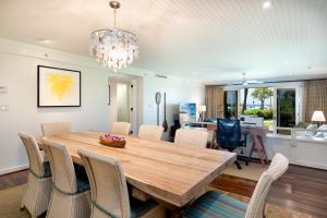 a dining room with a wooden table and chairs at Ocean Villas at Turtle Bay in Kahuku
