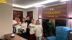 a group of people standing in front of a store at Pharaonic Pyramids Inn & jacuzzi in Cairo
