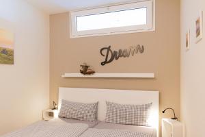 シャルボイツにあるFerienwohnung Strandhotel App. 105の白いベッドと窓のある寝室