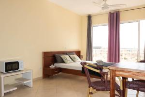 a bedroom with a bed and a table and a dining room at Beauty Plaza Apartaments in Santa Maria