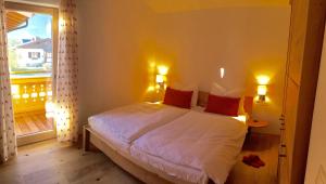 sypialnia z łóżkiem z 2 lampami i oknem w obiekcie Chalet Noriker w mieście Niedernsill