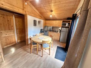 a kitchen and dining room with a table in a tiny house at Chalet 45m2 in Mios