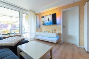 TV a/nebo společenská místnost v ubytování Ferienwohnung Strandbude 11 -Timmendorfer Strand