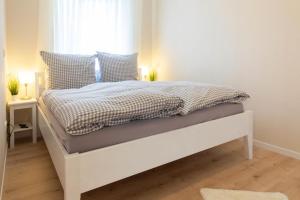Postel nebo postele na pokoji v ubytování Ferienwohnung Strandbude 11 -Timmendorfer Strand