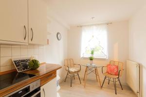 ハーフクルークにあるFerienhaus HaffPerleのキッチンにテーブルと椅子がある