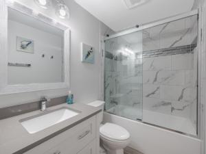 a bathroom with a sink and a shower and a toilet at Ocean Dunes 2002 in Kure Beach +20 photos