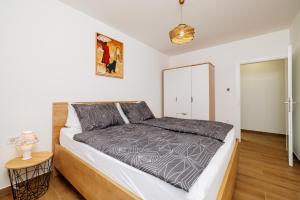 a bedroom with a bed and a night stand at Apartmani Viktorija in Jadranovo +52 photos