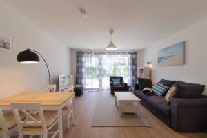 a living room with a couch and a table at Ferienwohnung Kurpark-Residenz App. 5 in Timmendorfer Strand