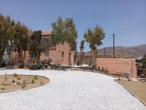 a large gravel driveway in front of a building at Blue Agave in Agios Sostis