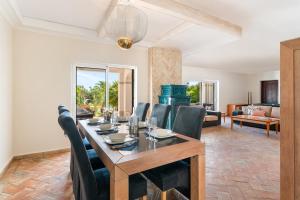 a dining room with a table and chairs at Luxury Casa Madeira, HEATED Salt Water Pool and Panoramic Woodfire Sauna in Lagos