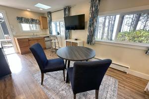 a kitchen and living room with a table and chairs at Ocean Front, Cottage at Oregon House, Stairs to the Beach! in Searose Beach