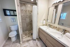a bathroom with a toilet and a sink and a shower at Ocean Front, Cottage at Oregon House, Stairs to the Beach! in Searose Beach +18 photos