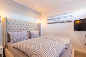 Postel nebo postele na pokoji v ubytování Ferienwohnung Aalkate App 1