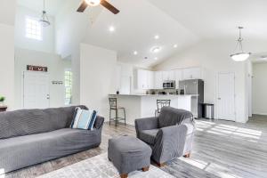 a living room with a couch and a chair and a kitchen at Savannah Lakes Village Home Golf and Hike! in McCormick