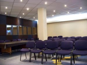 a conference room with blue chairs and a table at Hotel Don Simón in Toluca