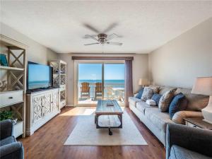 a living room with a couch and a table at Ocean Dunes 2112 in Kure Beach