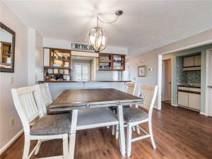 a kitchen and dining room with a table and chairs at Ocean Dunes 2112 in Kure Beach +17 photos