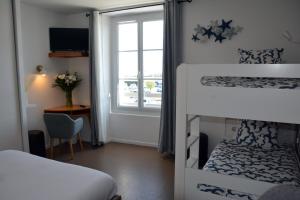 a bedroom with two bunk beds and a window at Atlantic Hôtel - L'Ile d'Yeu in L'Ile d'Yeu