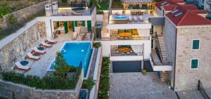 an aerial view of a house with a swimming pool at Luxury Residence Mladenka in Jesenice