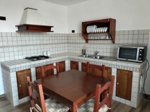 a kitchen with a wooden table and a stove at Piazza Varese in Valentano