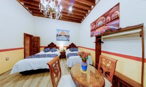 Postel nebo postele na pokoji v ubytování HOTEL CASA BAEZ