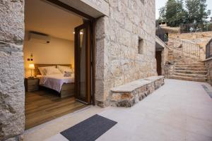 a bedroom with a bed and a stone wall at Villa Mila Imotski Makarska in Zmijavci +35 photos