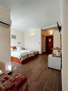 a hotel room with a bed and a table at CASA DEL SOL Sozopol in Sozopol