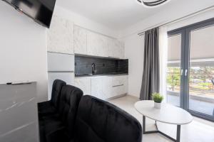 a living room with black chairs and a white table at Central Square View Flogita in Flogita
