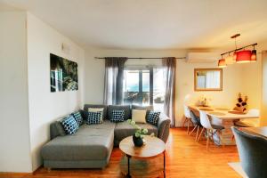 a living room with a couch and a table at Apartment Bečica in Omiš