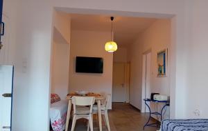a small room with a table and chairs and a bed at Lilian 2 in Batsi