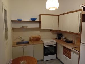 a kitchen with white cabinets and a sink at Lilian 2 in Batsi