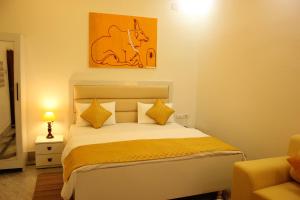 a bedroom with a bed with a picture of a horse on the wall at The Nandi International Boutique Stay in Varanasi