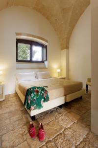 Postel nebo postele na pokoji v ubytování Masseria Corda Di Lana Hotel & Resort